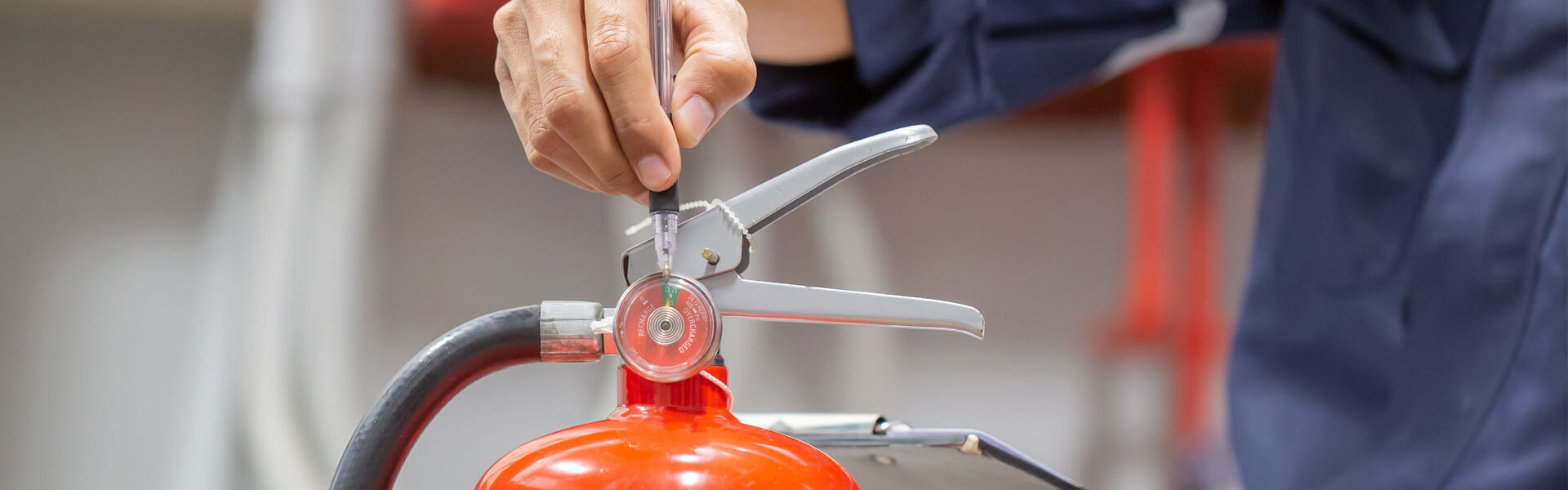 Checking a Fire Extinguisher During Assessment