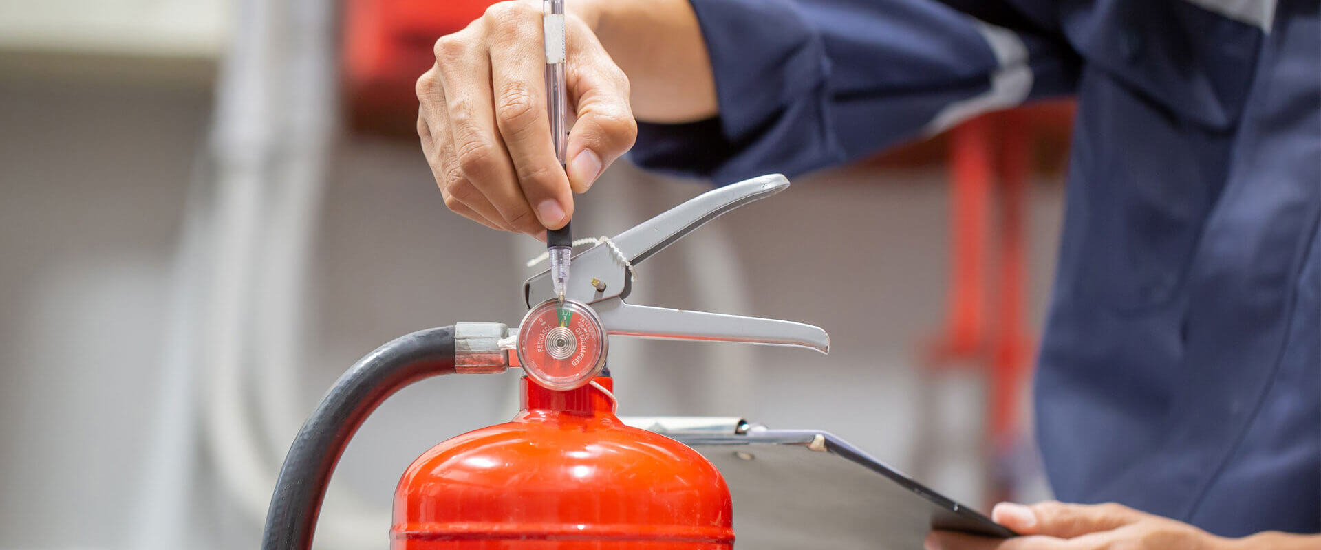 Checking a Fire Extinguisher During Assessment
